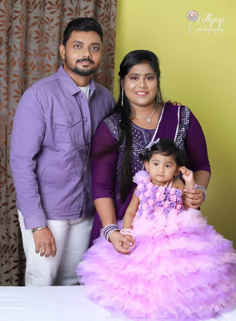 Family portrait with Sarah in her lovely purple dress, celebrating her first birthday. Captured by Lollipop Photography