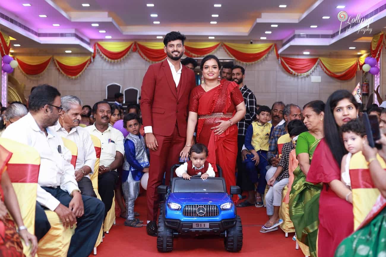 Kian's family makes a grand entrance with Kian riding a toy car, kicking off his birthday event in Chennai captured by Lollipop Photography.