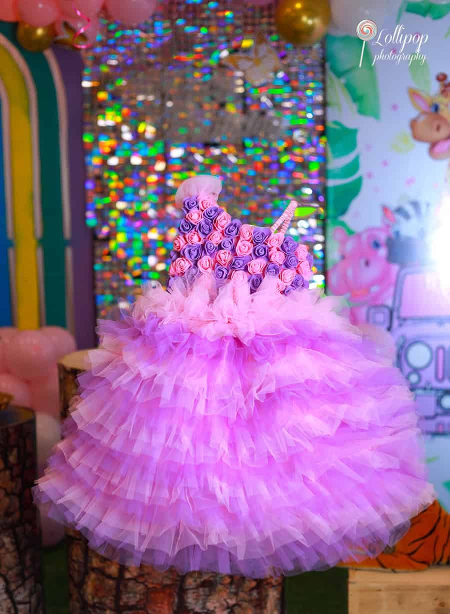 Beautiful purple rosette dress for Sarah's birthday photoshoot, adding a touch of elegance. Lollipop Photography