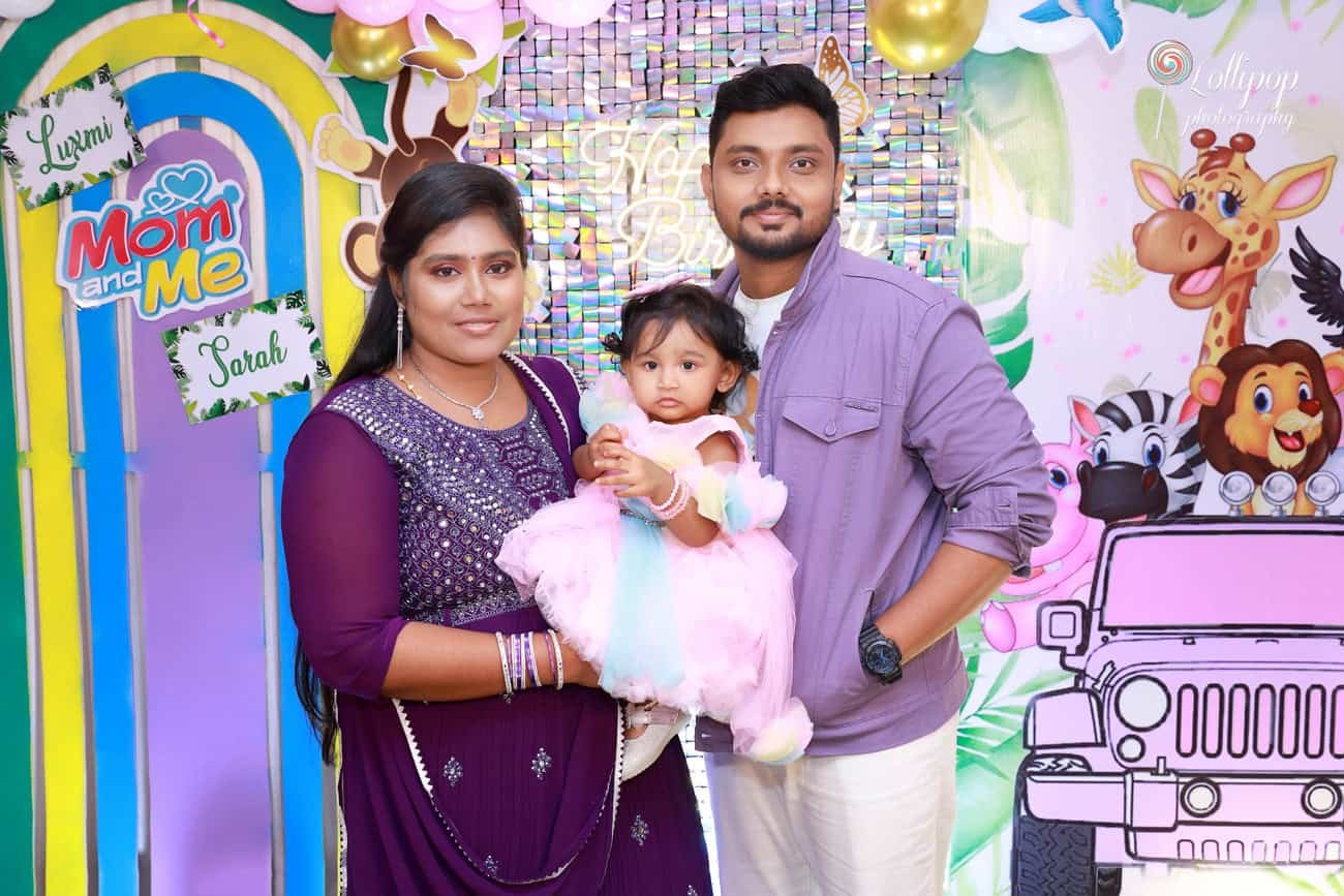 Sarah with her parents during her birthday celebration, a cherished family photo by Lollipop Photography.