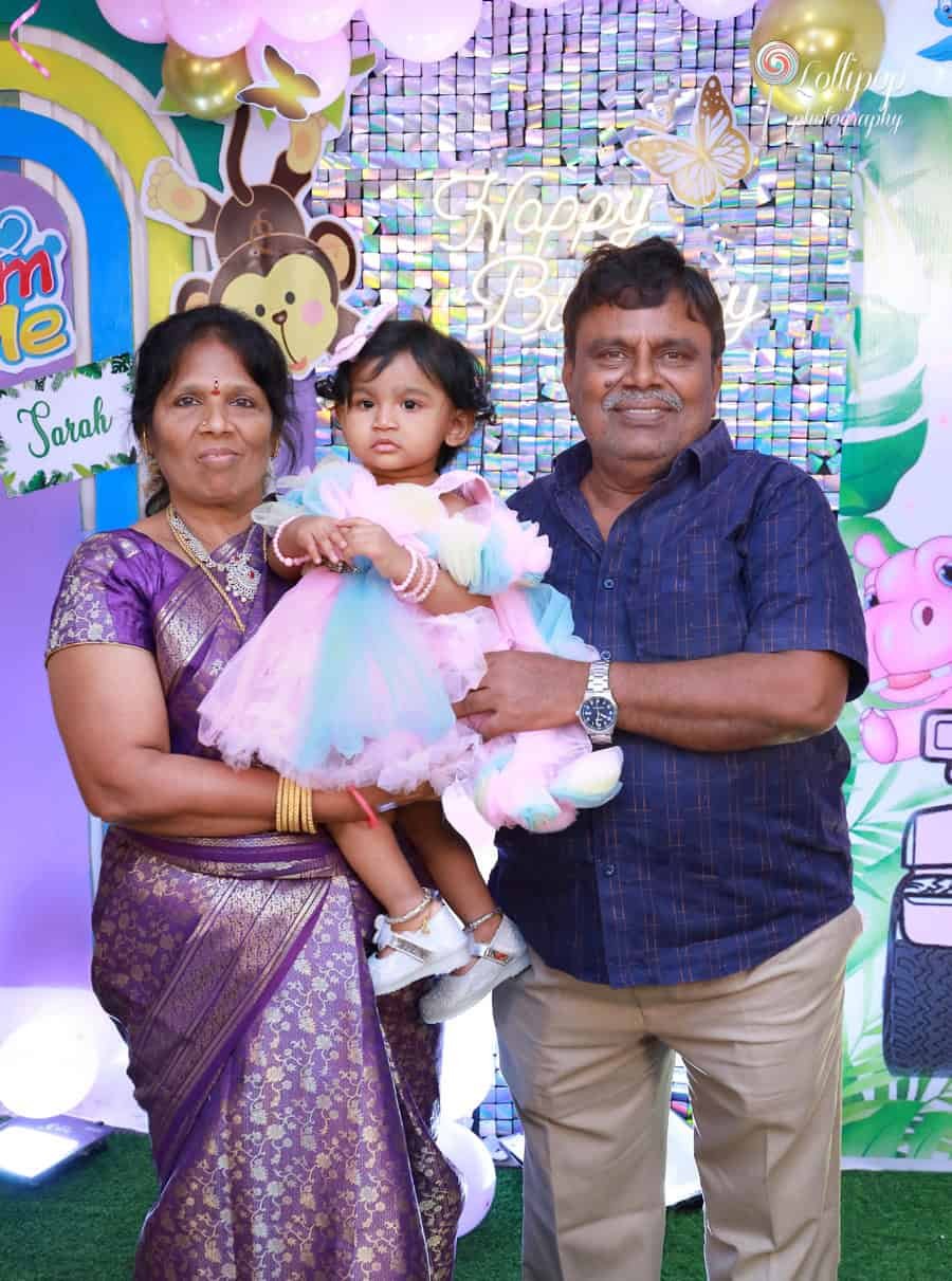 Sarah enjoying a special moment with her grandparents on her birthday, preserved by Lollipop Photography