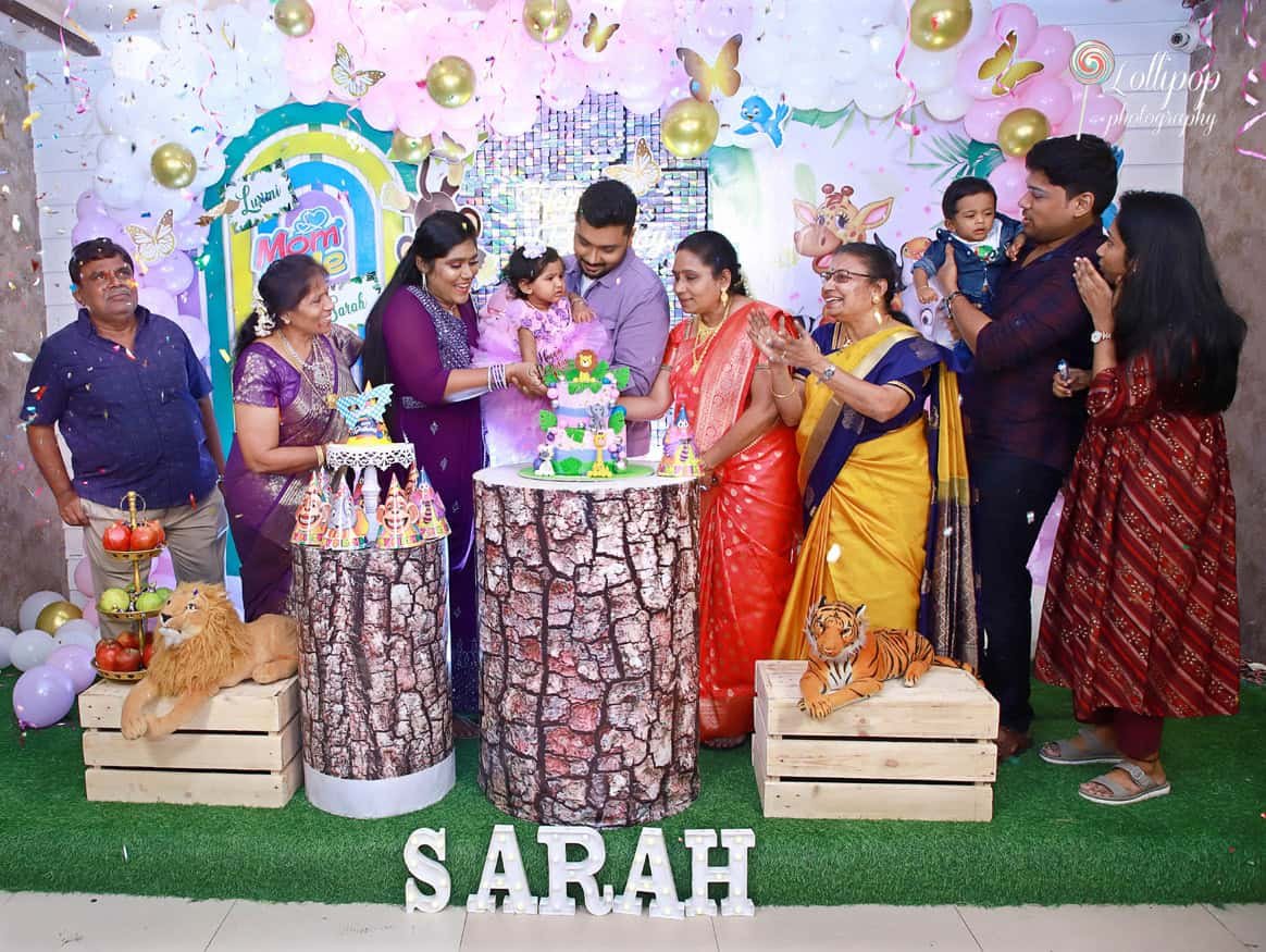 Sarah and her family gathered around her birthday cake, celebrating with love and joy, beautifully captured by Lollipop Photography.