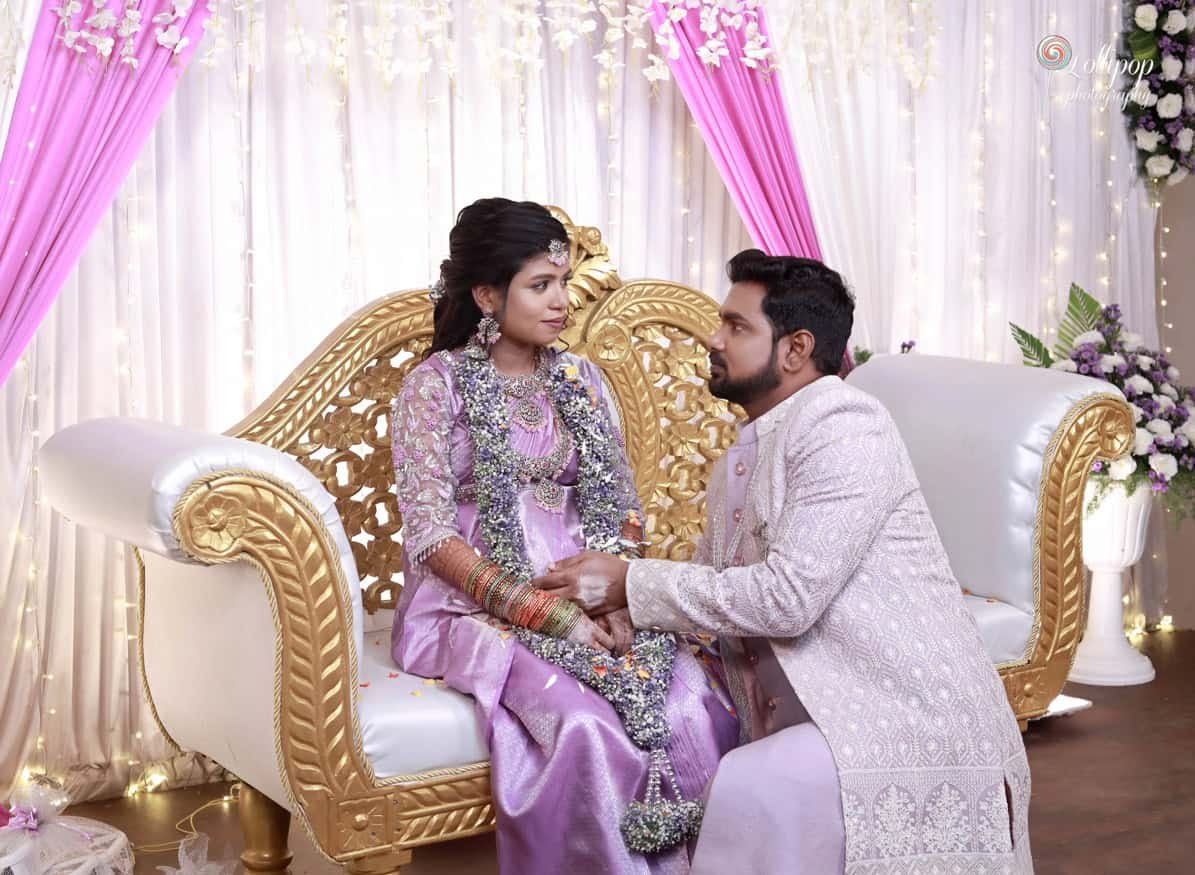 Bride-groom-sweet-moment-baby-shower-Lollipop-Photography A touching moment as the groom lovingly gazes at his bride, both adorned in traditional attire, creating an intimate atmosphere at their baby shower, captured by Lollipop Photography