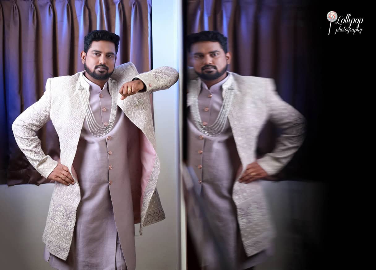 A stylish reflection portrait of the groom in elegant attire, adding a modern touch to the traditional baby shower event